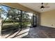 Large screened porch with ceiling fan, paver flooring, and views of the backyard at 1533 Emerald Dunes Dr, Sun City Center, FL 33573