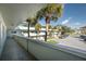 Balcony view of the apartment building, parking lot, and surrounding trees at 2386 Sumatran Way # 34, Clearwater, FL 33763