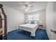 Cozy bedroom featuring a double bed and blue carpet at 2386 Sumatran Way # 34, Clearwater, FL 33763