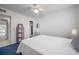 Bedroom with ceiling fan, blue carpet, white walls, and open closet at 2386 Sumatran Way # 34, Clearwater, FL 33763
