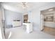 Bright bedroom with a desk, ceiling fan, and view into a galley-style kitchen at 2386 Sumatran Way # 34, Clearwater, FL 33763