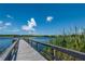 Wooden dock extending into a calm lake at 2386 Sumatran Way # 34, Clearwater, FL 33763