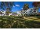 View of the exterior elevation of an apartment building, surrounded by lush green landscaping at 2386 Sumatran Way # 34, Clearwater, FL 33763
