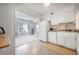 White kitchen with granite countertops, white appliances, and tile flooring at 2386 Sumatran Way # 34, Clearwater, FL 33763