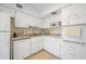 White kitchen with granite countertops and built-in microwave at 2386 Sumatran Way # 34, Clearwater, FL 33763