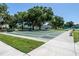 Shuffleboard courts in a community area, surrounded by trees and benches at 2386 Sumatran Way # 34, Clearwater, FL 33763