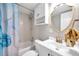 Bathroom with white vanity, gold fixtures, and a blue and gold shower curtain at 262 5Th Nw St, Largo, FL 33770