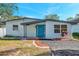 Charming single-story home with a teal front door and updated landscaping at 262 5Th Nw St, Largo, FL 33770