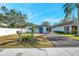 Inviting front yard with a paved driveway and a green mailbox at 262 5Th Nw St, Largo, FL 33770