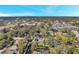 Aerial view of a neighborhood with houses, trees, and distant ocean views at 262 5Th Nw St, Largo, FL 33770