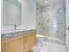 Modern bathroom with marble shower and wood vanity at 3020 W Santiago St # 4, Tampa, FL 33629