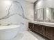 Double vanity bathroom with marble countertops and grey tile at 3020 W Santiago St # 4, Tampa, FL 33629