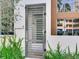 Modern gray metal gate with horizontal bars leading to the front entrance of the house at 3020 W Santiago St # 4, Tampa, FL 33629