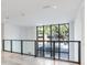 Bright hallway with large window and modern glass railing at 3020 W Santiago St # 4, Tampa, FL 33629