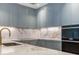 Modern kitchen with marble countertops and blue cabinets at 3020 W Santiago St # 4, Tampa, FL 33629