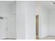 Open living space with white walls and hardwood floors, leading to bathroom at 3020 W Santiago St # 4, Tampa, FL 33629