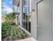 Private side entrance with a modern green door and small garden at 3020 W Santiago St # 4, Tampa, FL 33629