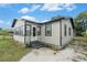 Tan bungalow with gray trim and a fenced yard at 3706 N 35Th St, Tampa, FL 33610