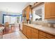 Bright eat-in kitchen with wood cabinets, bay window, and tile floor at 37226 Lakewood Dr, Zephyrhills, FL 33542