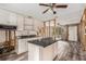 Kitchen with white cabinets, granite countertops, and an island at 6826 Driftwood Dr, Hudson, FL 34667