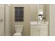 Modern bathroom with a walk-in shower, white vanity, and neutral-toned walls at 7046 E 113Th Ct, Palmetto, FL 34221