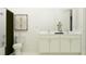 Bright bathroom with a white vanity, double sinks, a bathtub, and a toilet at 7046 E 113Th Ct, Palmetto, FL 34221