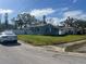 Gray, single-story home nestled on a grassy lot with white picket fence at 854 60Th Ne Ave, St Petersburg, FL 33703