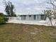 Home with a refreshing pool and white fence at 87 Rotonda Cir, Rotonda West, FL 33947