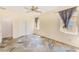 This large bedroom has a ceiling fan, and two windows with privacy curtains at 10014 Cannon Dr, Riverview, FL 33578