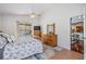 Bright bedroom with a queen-size bed, dresser, and access to a pool view at 10037 Oasis Palm Dr, Tampa, FL 33615