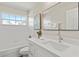 Modern bathroom featuring a vanity with a stone countertop, a large mirror, and a shower-tub combination at 11351 Callaway Pond Dr, Riverview, FL 33579