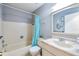 Bright bathroom featuring a bathtub, single vanity, and decorative mirror at 12221 Darwood Dr # D, Hudson, FL 34667