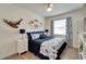 Bedroom with a navy and white bedding set and ceiling fan at 12316 Juniper Field Ct, Riverview, FL 33579