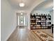 Bright living room with tile floors, built-in shelving and a piano at 12316 Juniper Field Ct, Riverview, FL 33579