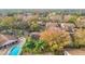 Aerial view of the community pool, lush trees, and townhouses at 12914 Fairway Dr # A, Hudson, FL 34667