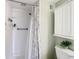 Modern bathroom with walk-in shower, updated fixtures, and decorative shower curtain at 12914 Fairway Dr # A, Hudson, FL 34667