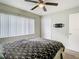 Comfortable bedroom with ceiling fan, closet, and large window at 12914 Fairway Dr # A, Hudson, FL 34667