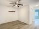 Empty bedroom with wood-look flooring and a ceiling fan at 12914 Fairway Dr # A, Hudson, FL 34667