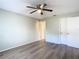 Bedroom with ceiling fan, wood-look floors, and neutral walls at 12914 Fairway Dr # A, Hudson, FL 34667