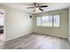 Spacious bedroom with large window, wood-look floors, and ceiling fan at 12914 Fairway Dr # A, Hudson, FL 34667