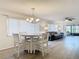 Dining area with a round table, chandelier, and view of living area at 12914 Fairway Dr # A, Hudson, FL 34667