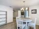 Dining area with a chandelier, round table, and view into the kitchen at 12914 Fairway Dr # A, Hudson, FL 34667
