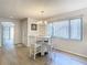Dining area with white chairs, round table, and chandelier at 12914 Fairway Dr # A, Hudson, FL 34667