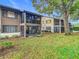 Condo exterior showcasing the screened porch and surrounding trees at 12914 Fairway Dr # A, Hudson, FL 34667