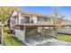 View of the condo's exterior, carport, and surrounding greenery at 12914 Fairway Dr # A, Hudson, FL 34667
