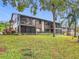 View of the condo building exterior with screened porches and green lawn at 12914 Fairway Dr # A, Hudson, FL 34667