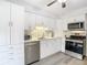 Bright kitchen with stainless steel appliances and white cabinets at 12914 Fairway Dr # A, Hudson, FL 34667