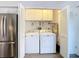 Laundry closet with washer, dryer, and extra shelving at 12914 Fairway Dr # A, Hudson, FL 34667