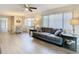 Living room features gray sofa, dining table, and laminate flooring at 12914 Fairway Dr # A, Hudson, FL 34667