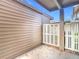 Small patio area with adjacent fence and building at 12914 Fairway Dr # A, Hudson, FL 34667